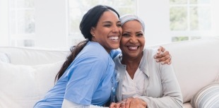 A nurse provides comfort to a cancer patient