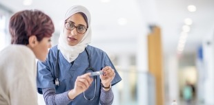 Doctor explaining insulin pen to patient