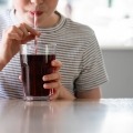 A child sips on a sugary drink