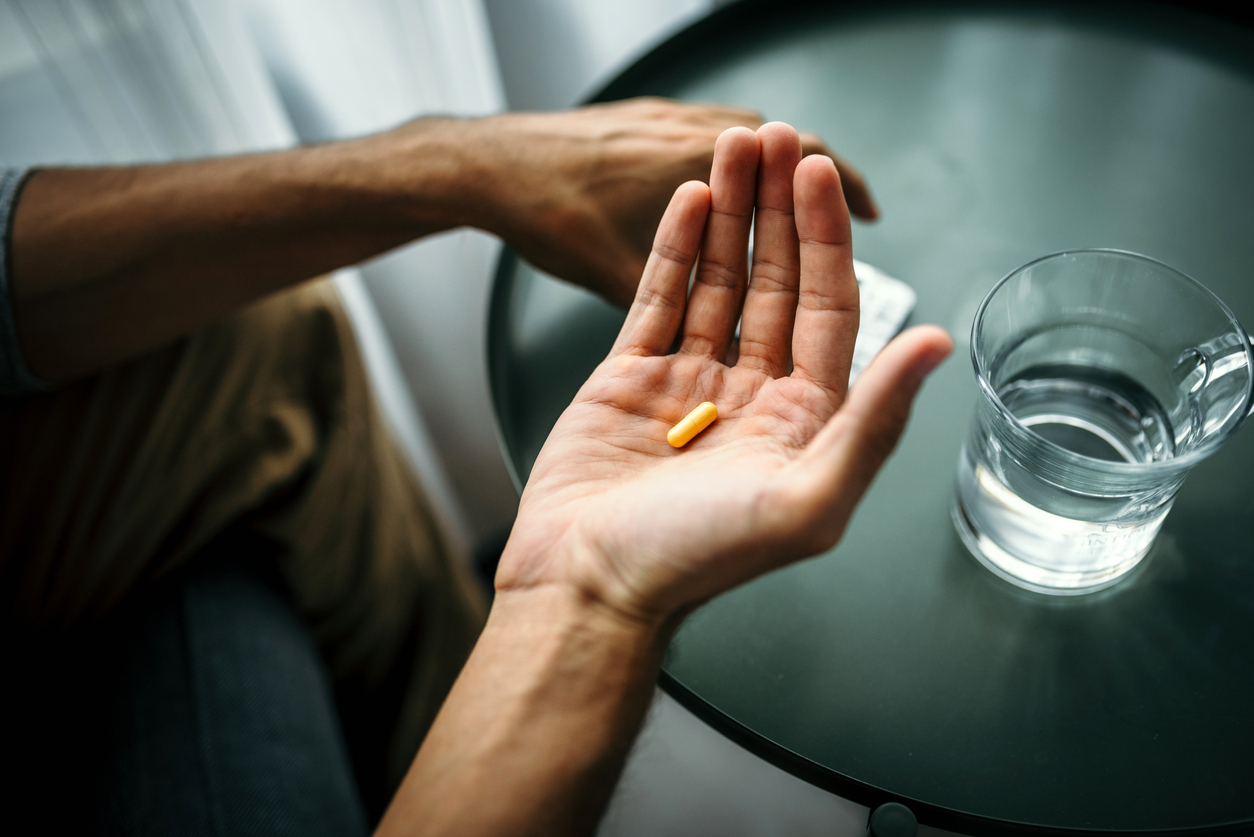 A person holds a pill