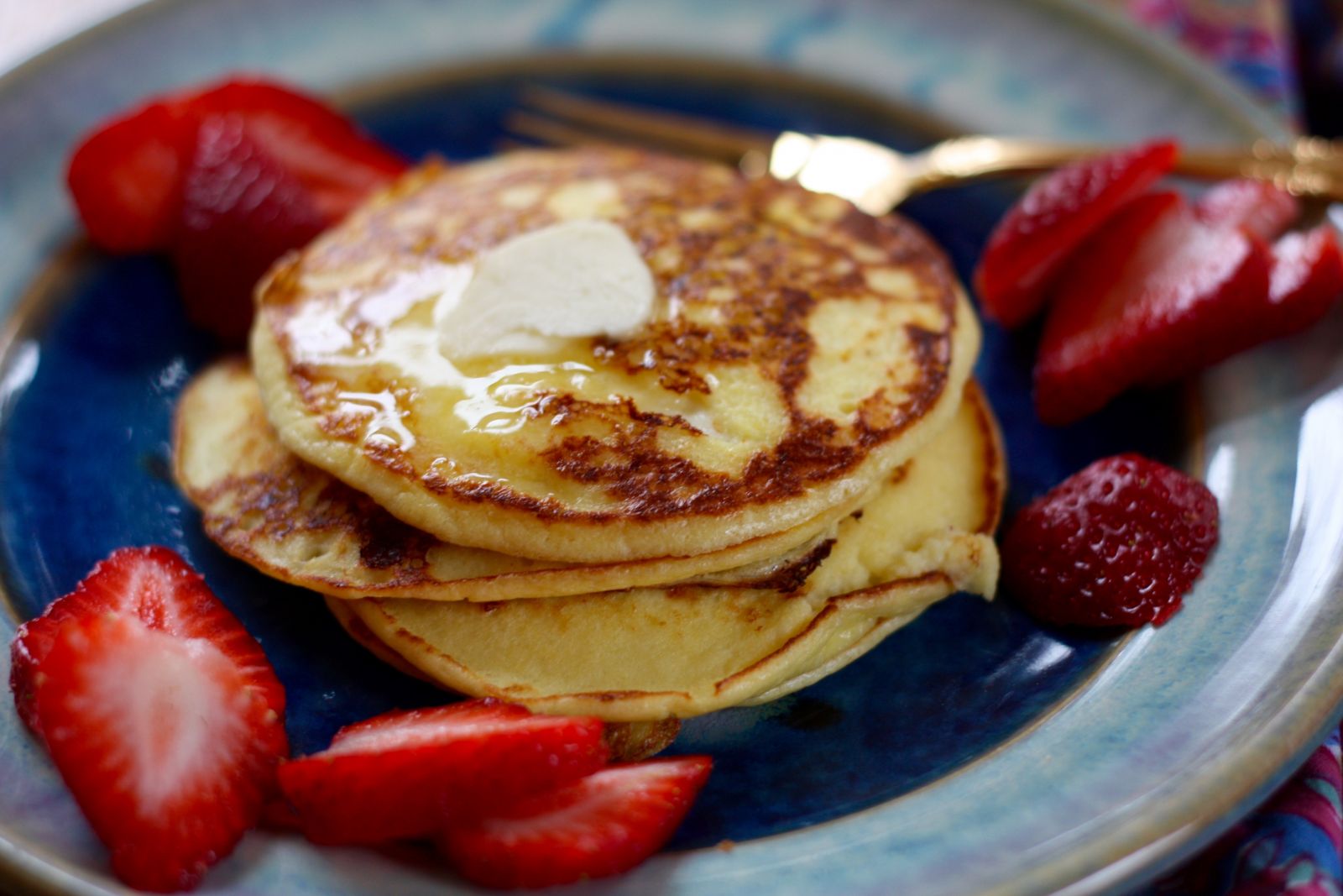 Cottage Cheese Pancakes with butter and sliced strawberries