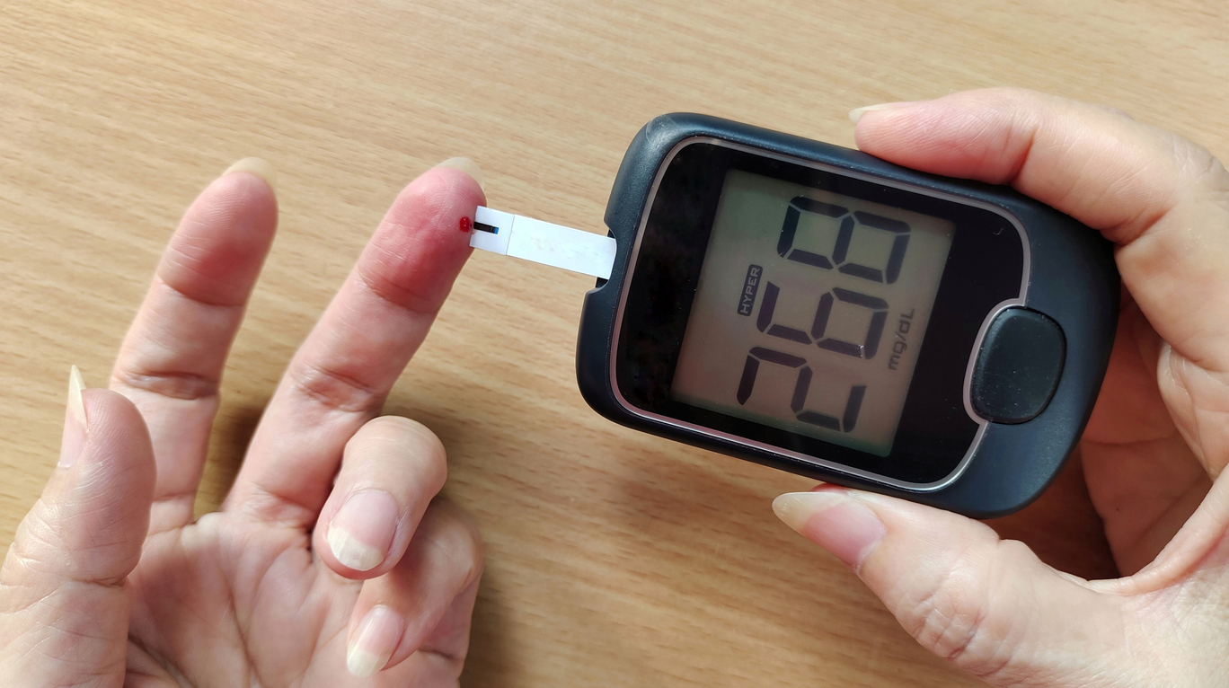 A person with diabetes checks their blood sugar levels