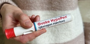 A person holds a ready-to-use glucagon pen for hypoglycemia