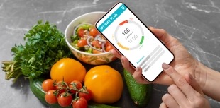 A person uses a smartphone app to track food habits