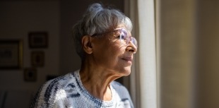 older woman looking out window