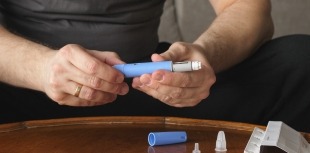 Man preparing diabetes drug injection