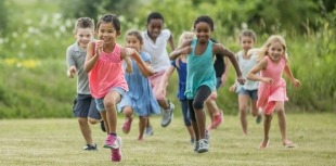 A group of children running outside