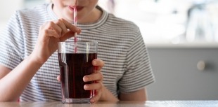 A child sips on a sugary drink