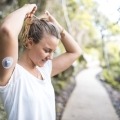 A young woman uses a CGM to manage her diabetes