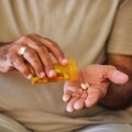 An older person takes their medication
