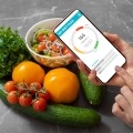 A person uses a smartphone app to track food habits