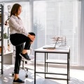 A woman does a short burst of exercise at her desk