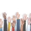 group of people raising hands